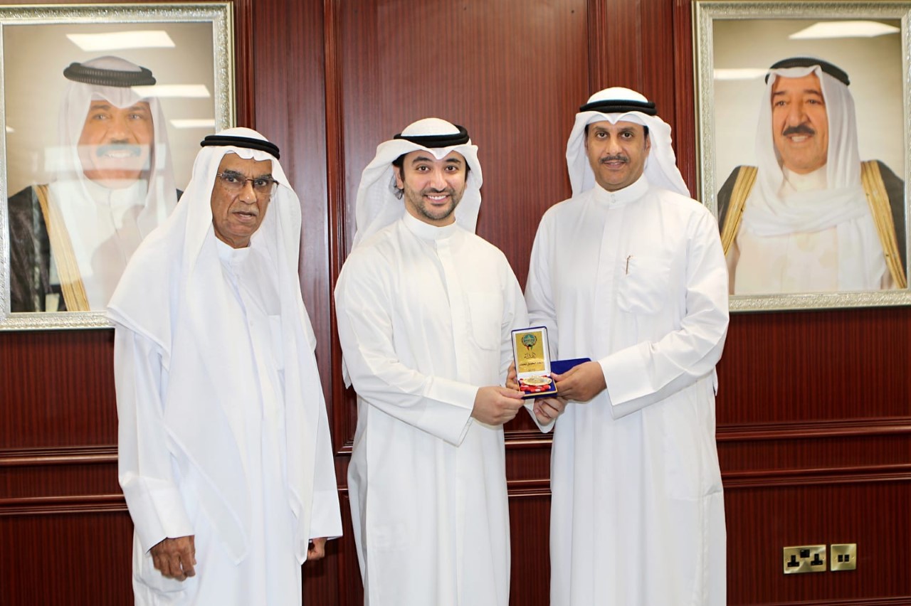 ناصر الهلفي يقدم درع للدكتور صقر الملا بحضور رئيس الاتحاد الكويتي للجمباز فهد الصولة.